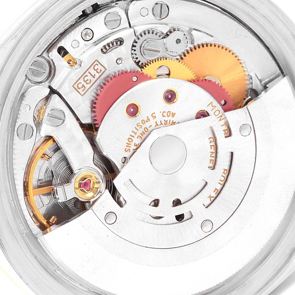 This is a close-up view of the internal mechanism of a Rolex Datejust 16233 Men's Steel and Gold (two tone) Champagne Dial 16233 Men's Steel and Gold (two tone) Champagne Dial watch, showing gears and intricate components.