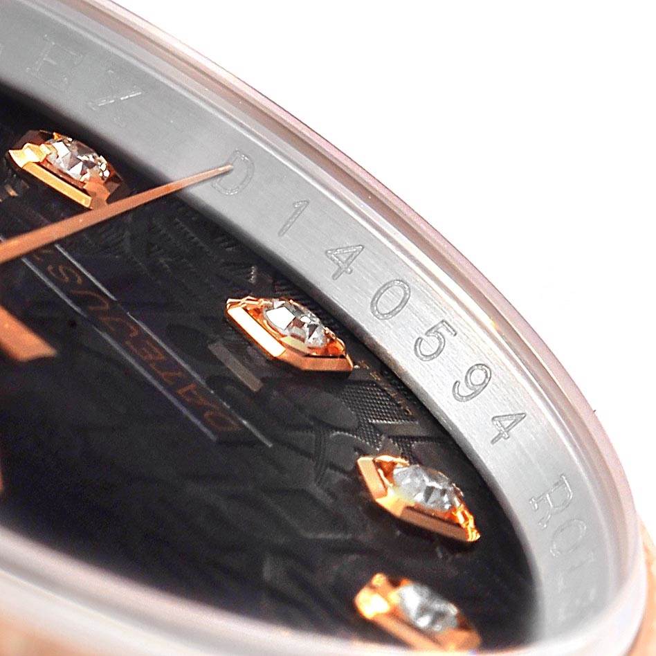 This is a close-up of the dial and inner bezel of a Rolex Datejust 116231 Men's Steel and Gold (two tone) Black Dial 116231 Men's Steel and Gold (two tone) Black Dial watch, showing diamond markers and engraved serial numbers.