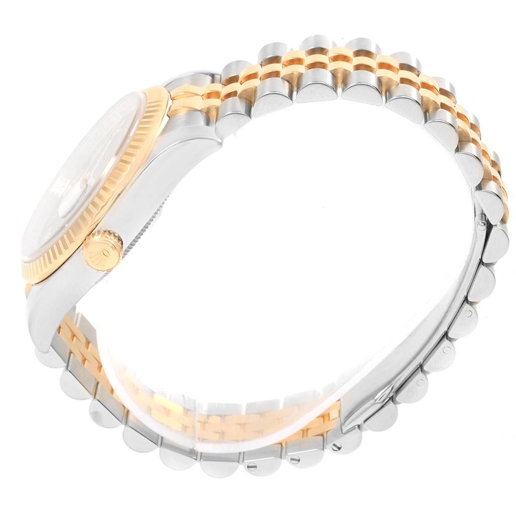 The image shows a side view of a Rolex Datejust 116233 Men's Stainless Steel Black Dial 116233 Men's Stainless Steel Black Dial watch, highlighting its two-tone Jubilee bracelet, fluted bezel, and crown.