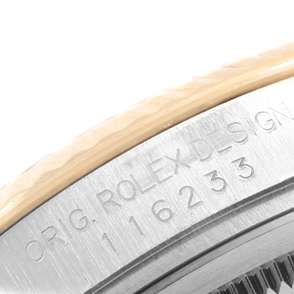 This image shows a close-up of the engraved casing edge of a Rolex Datejust 116233 Men's Stainless Steel Black Dial 116233 Men's Stainless Steel Black Dial watch, displaying the model number 116233.