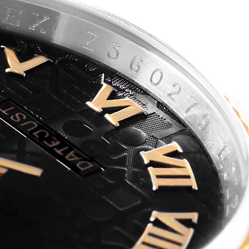 The image shows a close-up angle of the dial and part of the case of the Rolex Datejust 116233 Men's Stainless Steel Black Dial 116233 Men's Stainless Steel Black Dial watch, highlighting the Roman numeral markers and serial number.