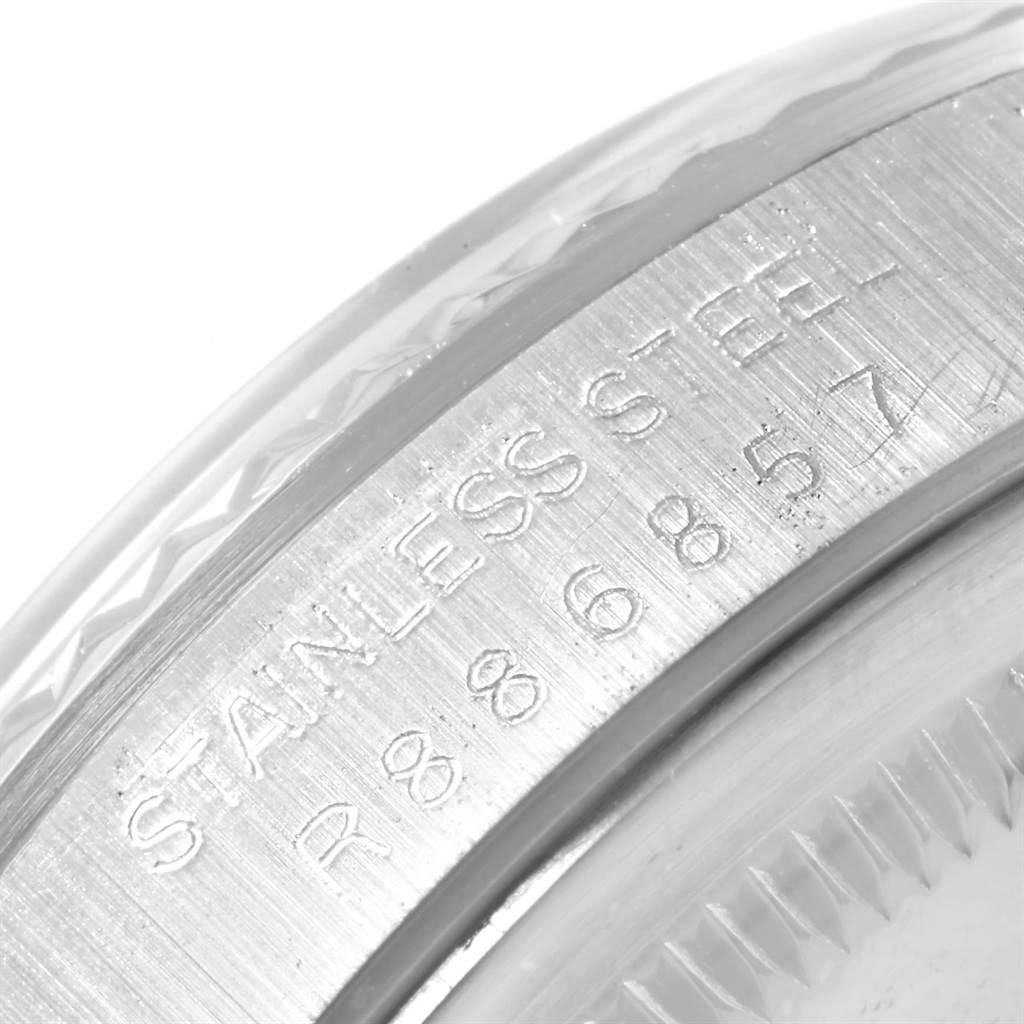 The image shows an angled close-up of the serial number engraving on the stainless steel bezel of a Rolex Datejust 16234 Men's Stainless Steel Silver Dial 16234 Men's Stainless Steel Silver Dial watch.