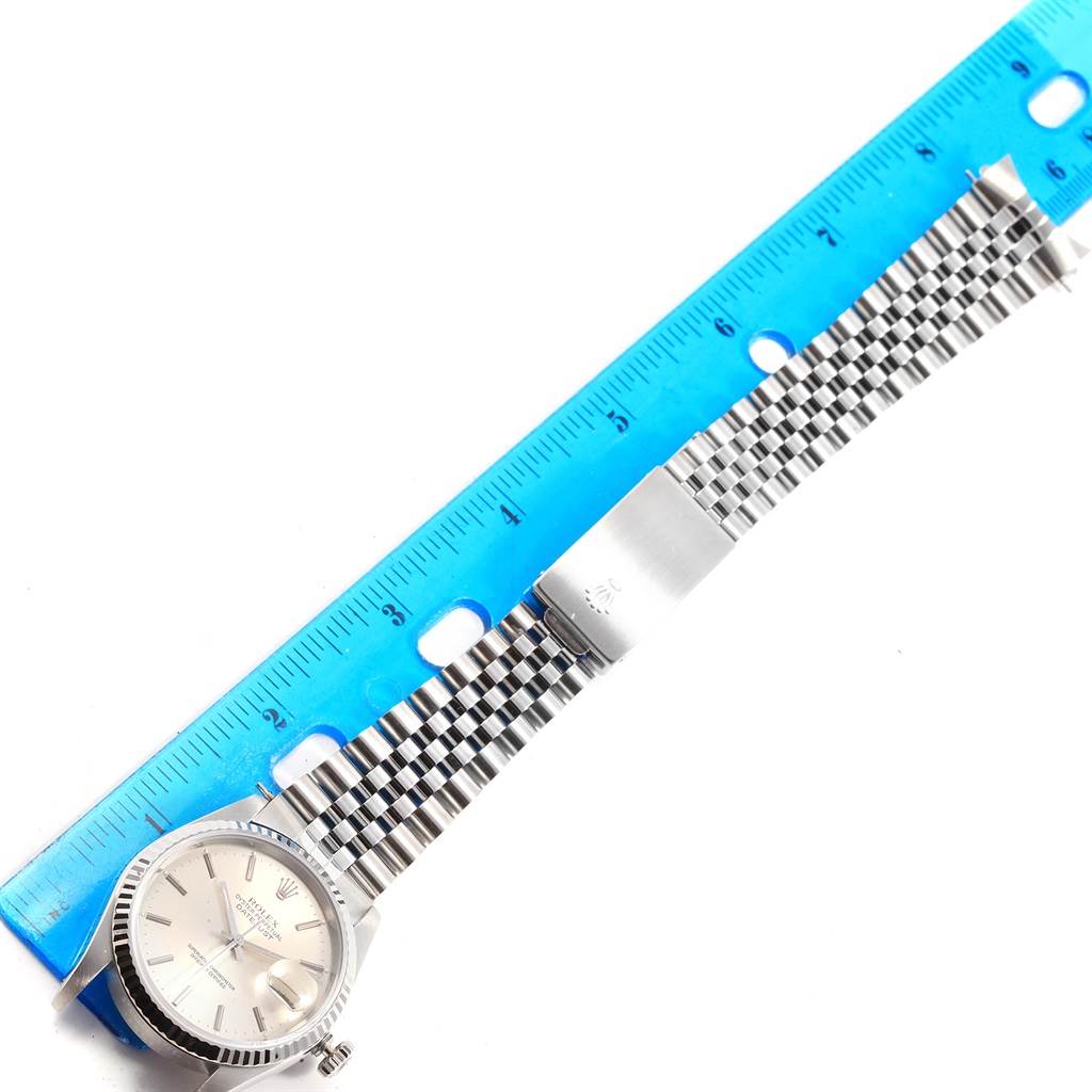 This is a top-down view of a Rolex Datejust 16234 Men's Stainless Steel Silver Dial 16234 Men's Stainless Steel Silver Dial watch, showing the dial, bracelet, and clasp alongside a ruler.