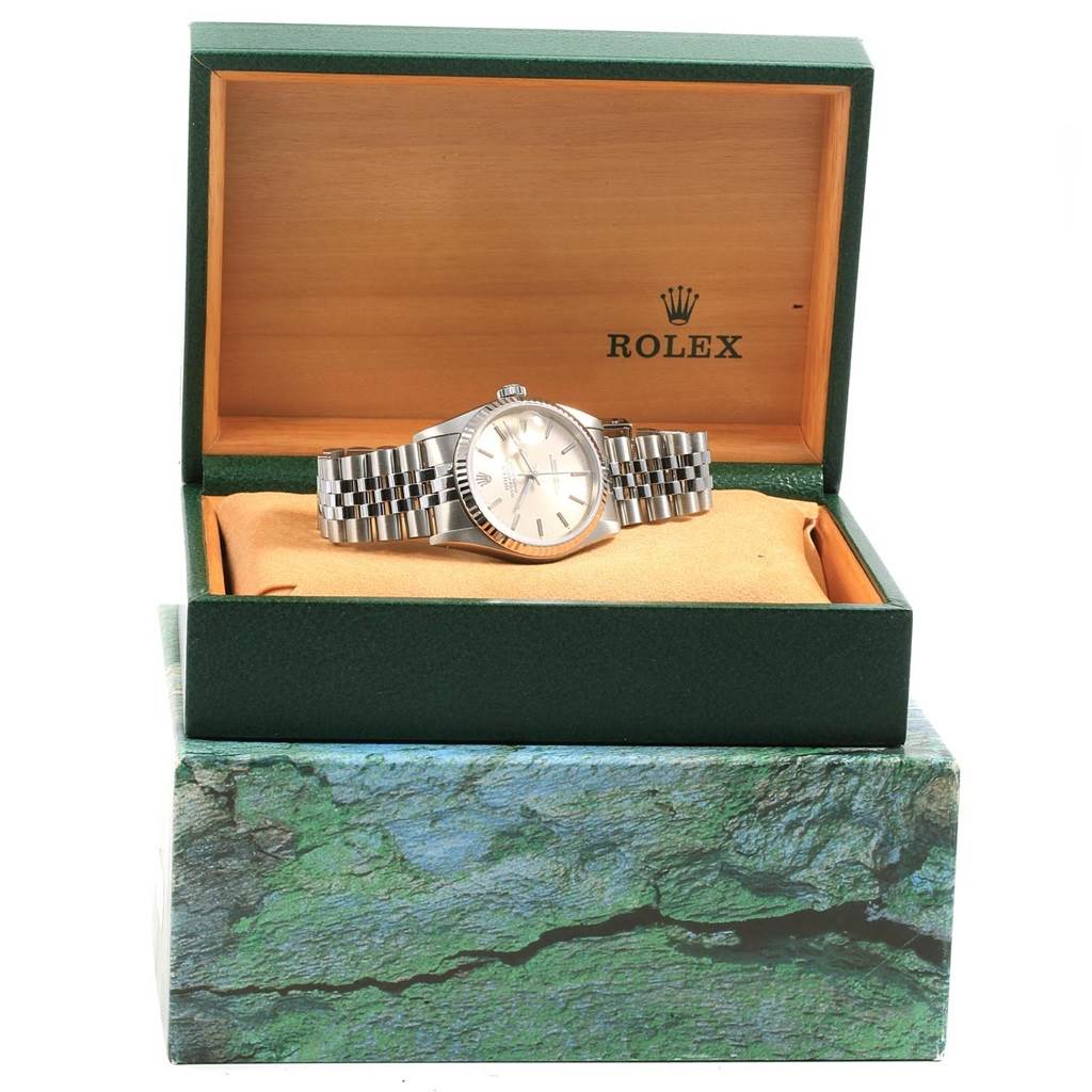 The Rolex Datejust 16234 Men's Stainless Steel Silver Dial 16234 Men's Stainless Steel Silver Dial watch is shown from the front, lying flat in its open green and wood-accented box.