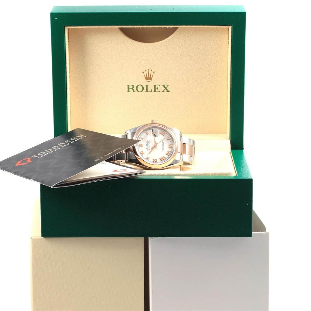 The Rolex Datejust 116201 Men's Steel and Gold (two tone) White Dial 116201 Men's Steel and Gold (two tone) White Dial watch is displayed in an open green box with the booklet partially covering it.
