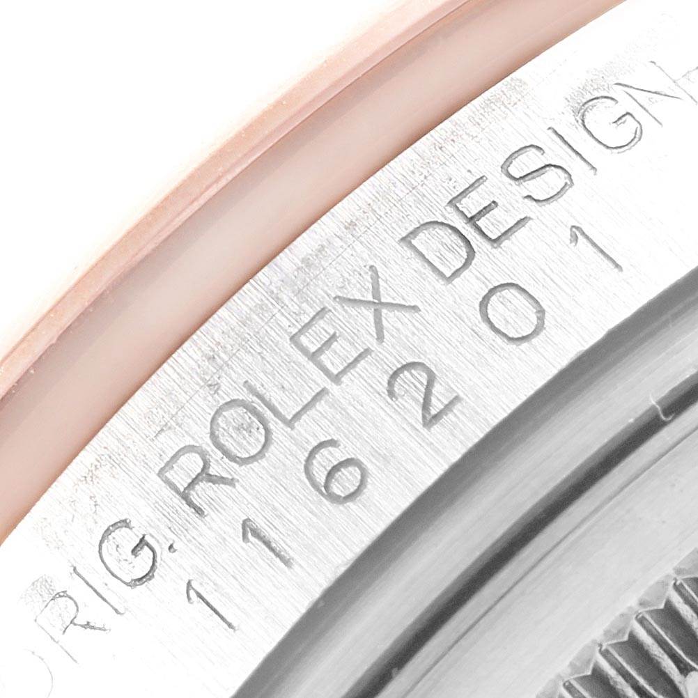This close-up image shows the serial engraving on the case of a Rolex Datejust 116201 Men's Steel and Gold (two tone) White Dial 116201 Men's Steel and Gold (two tone) White Dial watch.