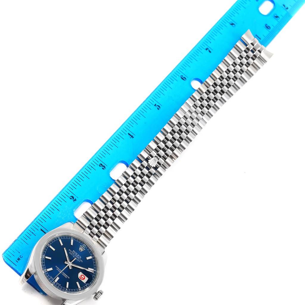 The image shows a Rolex Datejust 116200 Men's Stainless Steel Blue Dial 116200 Men's Stainless Steel Blue Dial watch from a top angle, featuring the watch face, strap, and a ruler for size reference.