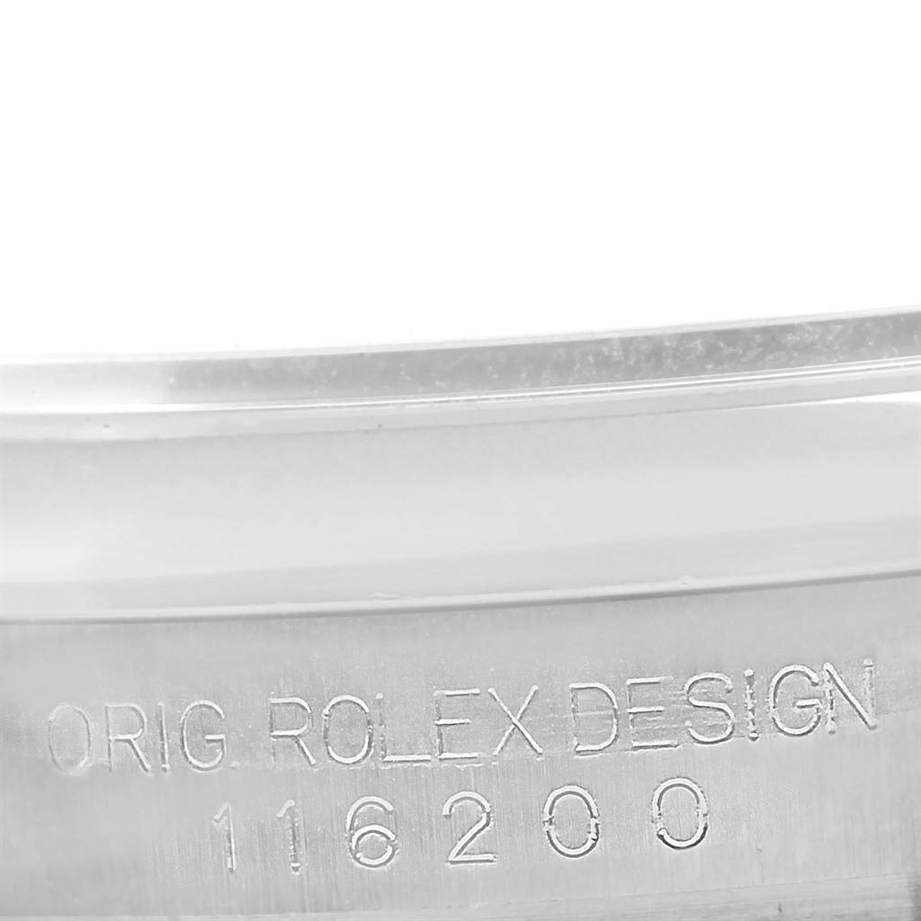 This image shows the engraved side of the case for a Rolex Datejust 116200 Men's Stainless Steel Blue Dial 116200 Men's Stainless Steel Blue Dial model, displaying the design number "116200."