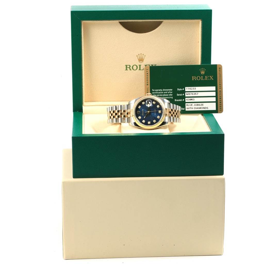 The Rolex Datejust 116233 Men's Stainless Steel Blue Dial 116233 Men's Stainless Steel Blue Dial watch is displayed front-on in its green box with its authentication card.