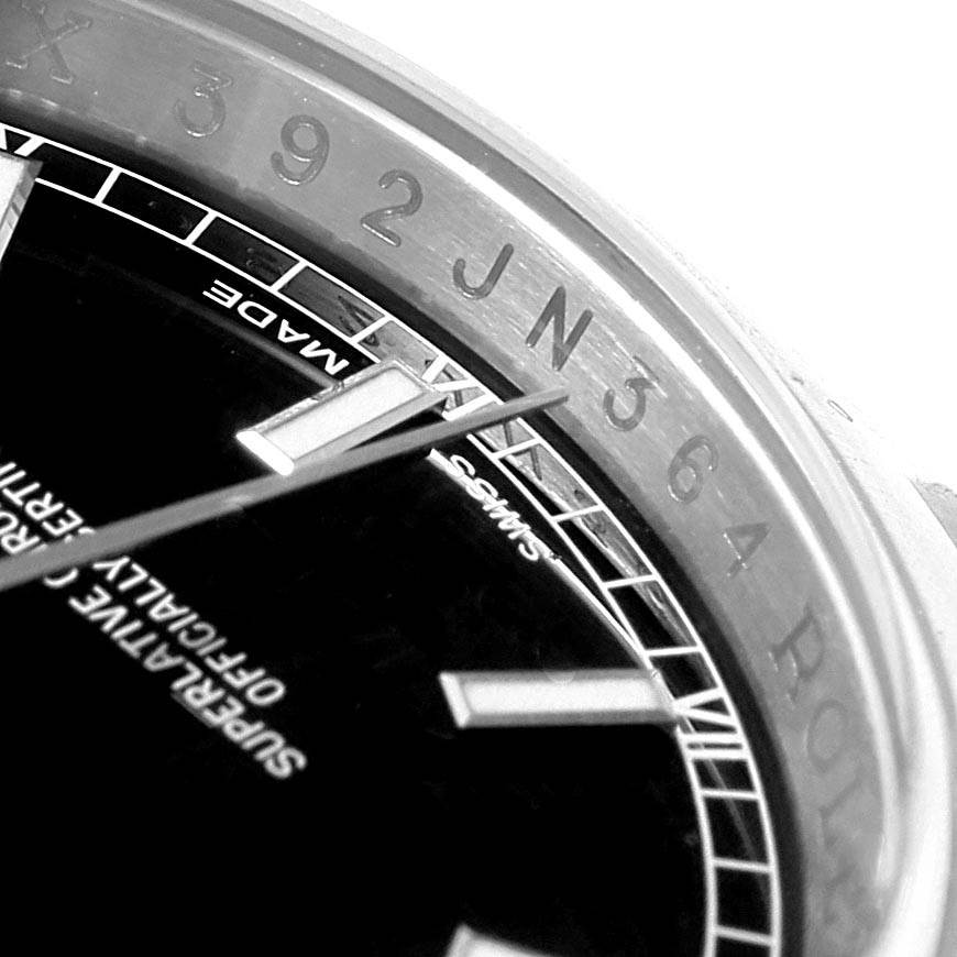 The image shows a close-up angle of the dial, bezel, and hands of a Rolex Datejust 116200 Men's Stainless Steel Black Dial 116200 Men's Stainless Steel Black Dial watch.