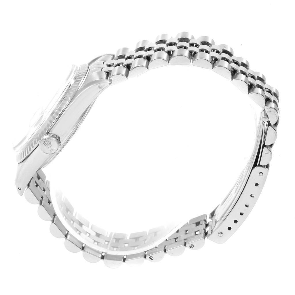 The image shows a side view of the Rolex Datejust 1601 Men's Stainless Steel Black Dial 1601 Men's Stainless Steel Black Dial watch, highlighting its case, fluted bezel, crown, and Jubilee bracelet.