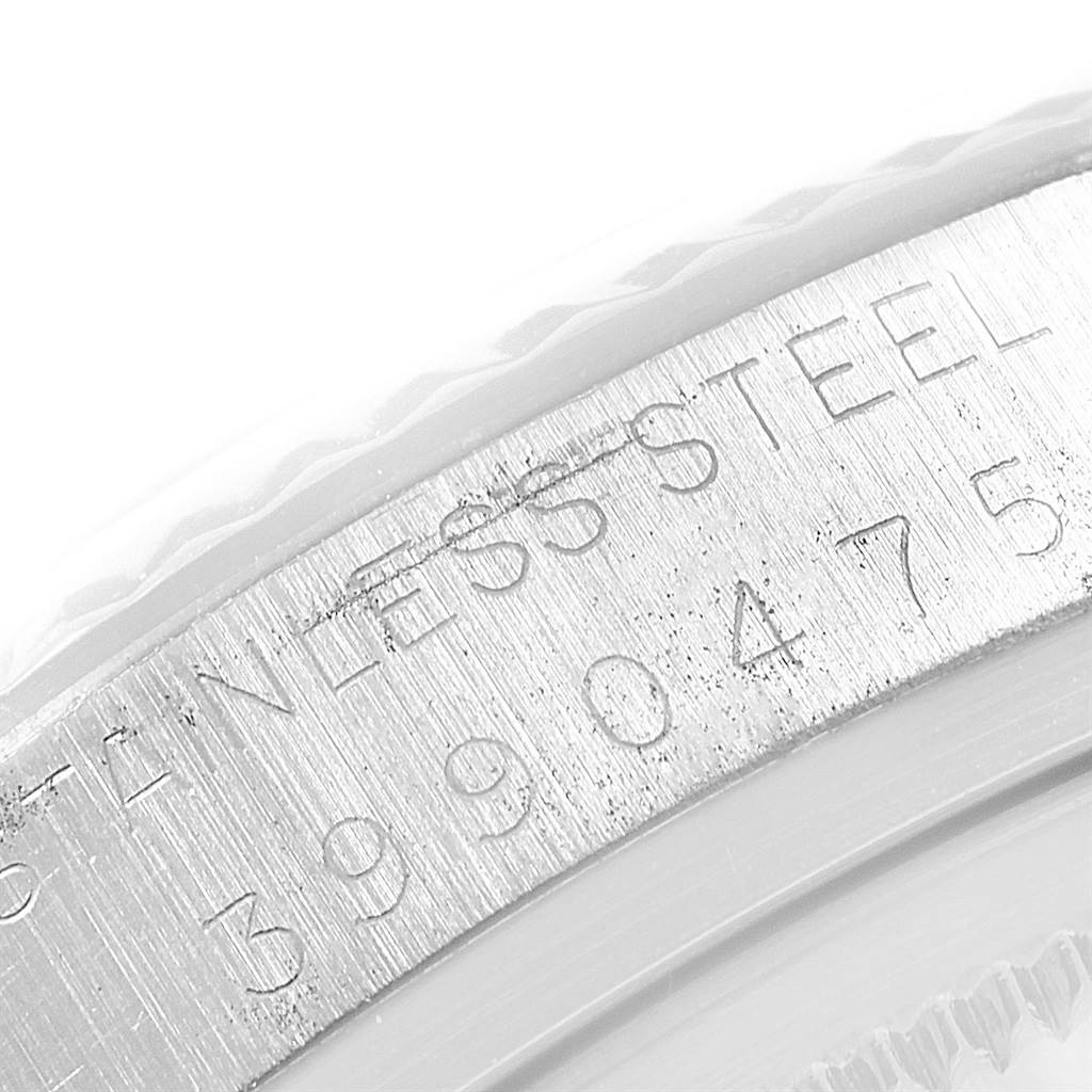 The image shows a close-up angle of the engraved bezel on a Rolex Datejust 1601 Men's Stainless Steel Black Dial 1601 Men's Stainless Steel Black Dial watch, featuring the text "STAIN LESS STEEL."
