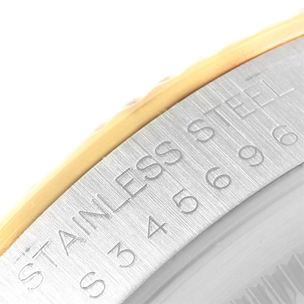 This close-up image of the Rolex Datejust 16233 Men's Steel and Gold (two tone) Champagne Dial 16233 Men's Steel and Gold (two tone) Champagne Dial shows the edge of the bezel and the side of the case engraved with "STAINLESS STEEL."