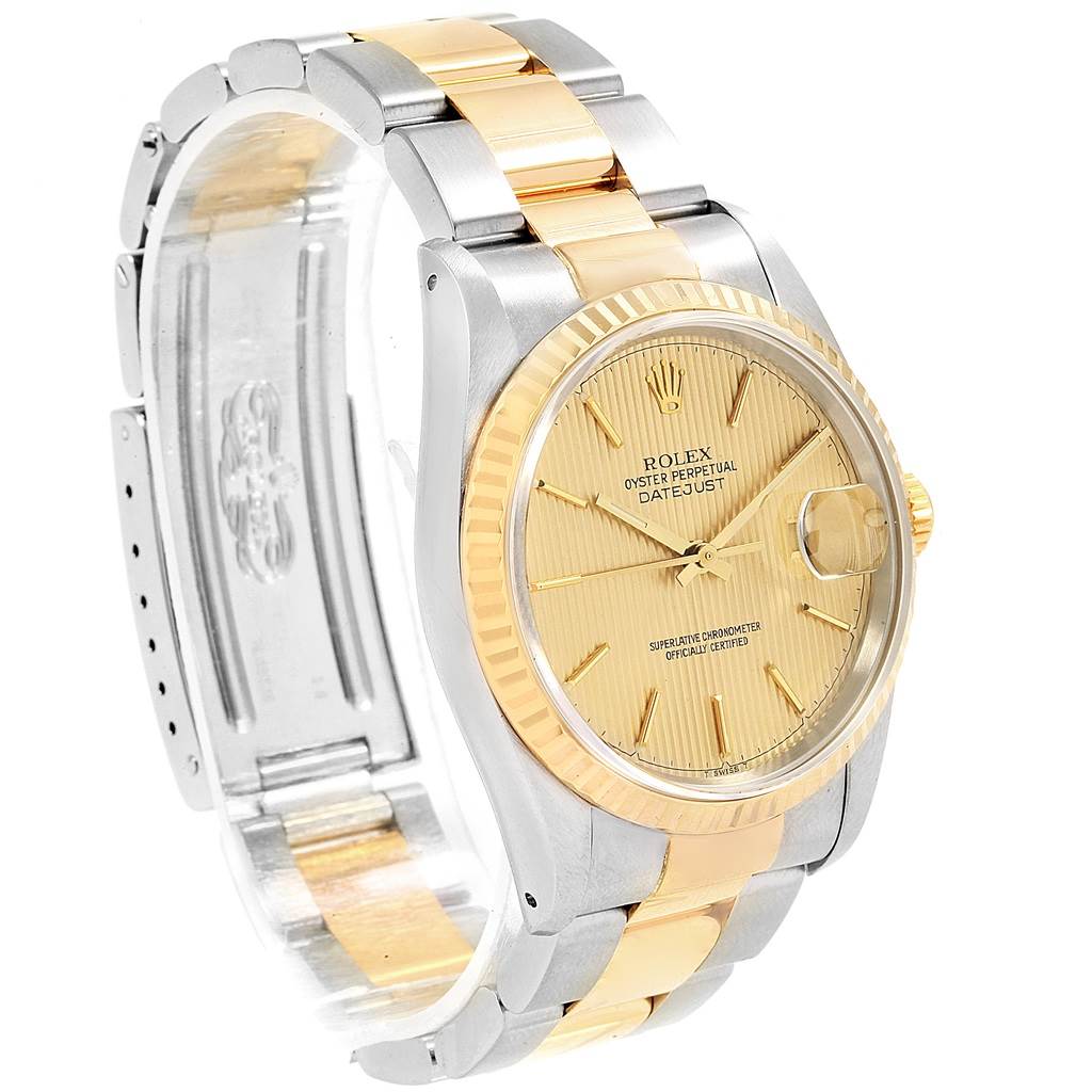 The image shows a side angle of a Rolex Datejust 16233 Men's Steel and Gold (two tone) Champagne Dial 16233 Men's Steel and Gold (two tone) Champagne Dial watch, highlighting its gold dial, two-tone bracelet, and fluted bezel.