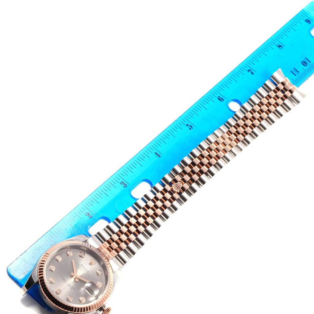 The image shows a Rolex Datejust 116231 Men's Steel and Gold (two tone) Grey Dial 116231 Men's Steel and Gold (two tone) Grey Dial watch from a top-down angle, highlighting the face, bezel, and part of the band next to a blue ruler.