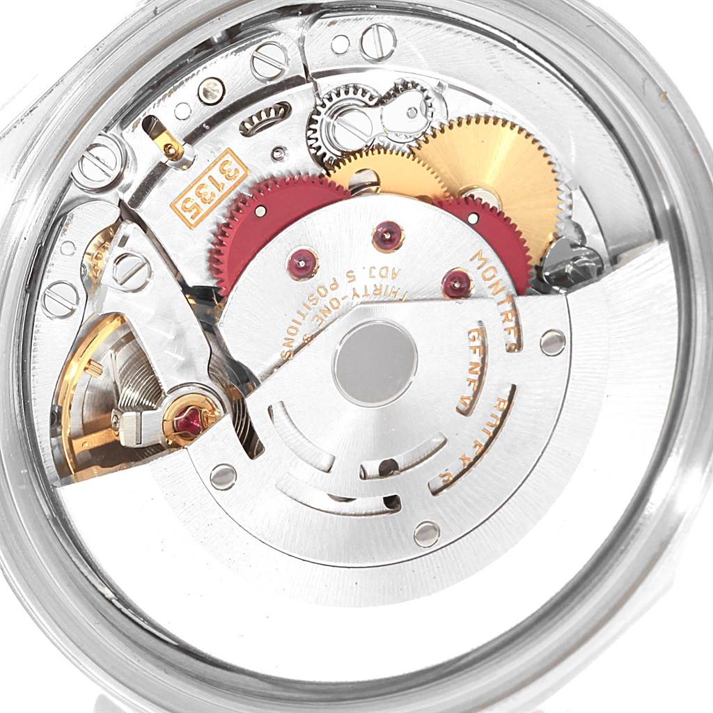 The image shows a close-up view of the internal mechanical movement of a Rolex Datejust 16220 Men
s Stainless Steel White Dial 16220 Men
s Stainless Steel White Dial watch, highlighting gears and mechanisms.