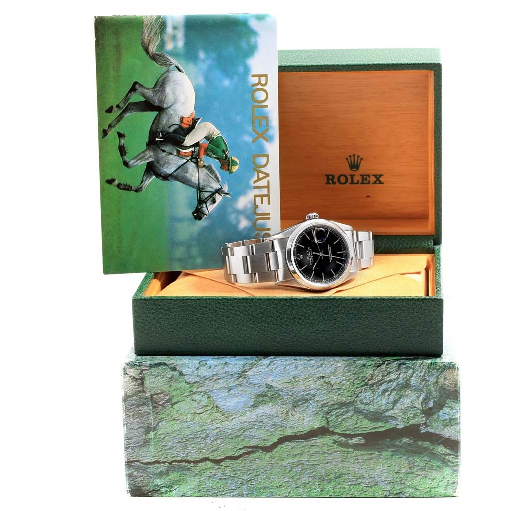The image shows a Rolex Datejust 16200 Men's Stainless Steel Black Dial 16200 Men's Stainless Steel Black Dial watch at a frontal angle, placed in its open box with the instruction manual displayed behind.