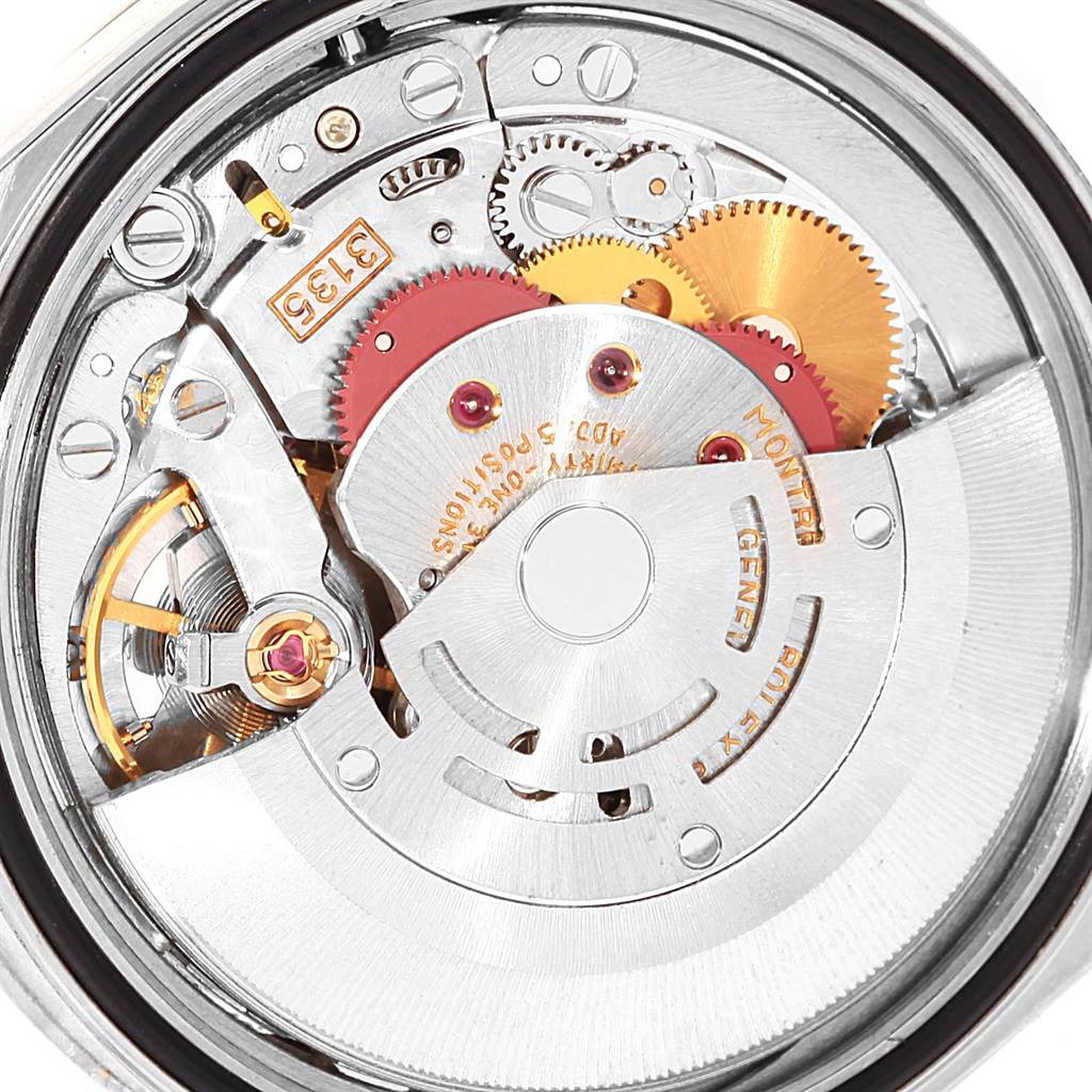 The image shows a close-up view of the Rolex Datejust 16220 Men's Stainless Steel Black Dial 16220 Men's Stainless Steel Black Dial watch's inner mechanical movement components, including gears and the rotor.