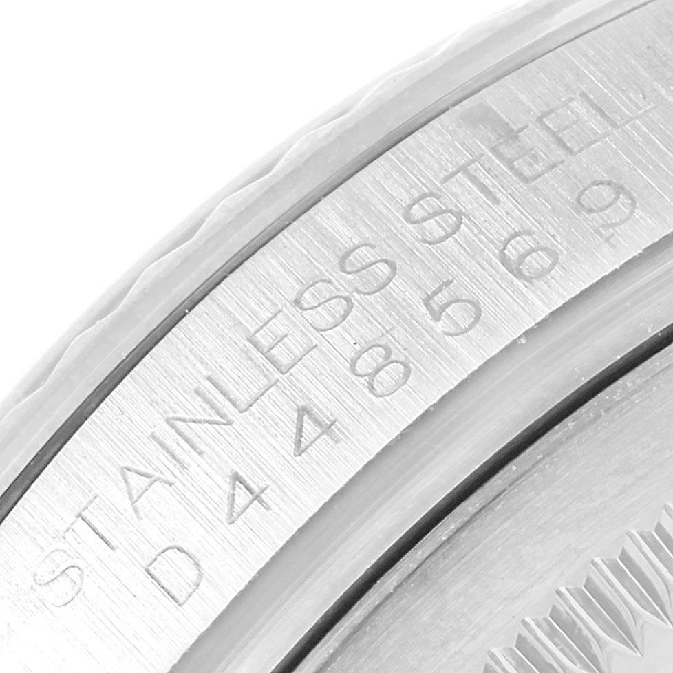 This close-up image shows the engraved details on the inner bezel of a Rolex Datejust 116234 Men's Stainless Steel Mother of Pearl Dial 116234 Men's Stainless Steel Mother of Pearl Dial watch.