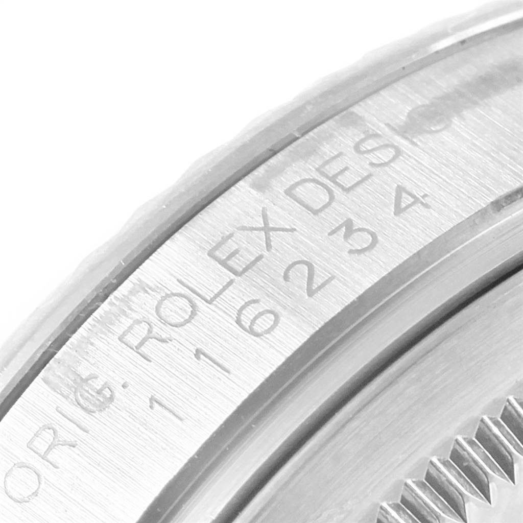 This image shows a close-up of the inner bezel and part of the case back of a Rolex Datejust 116234 Men's Stainless Steel Mother of Pearl Dial 116234 Men's Stainless Steel Mother of Pearl Dial watch.
