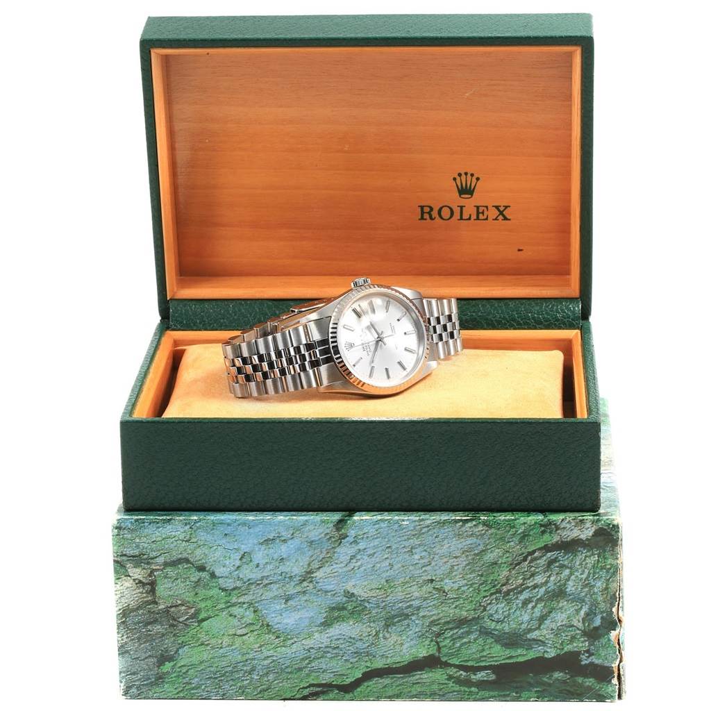 The Rolex Datejust 16234 Men's Stainless Steel Silver Dial 16234 Men's Stainless Steel Silver Dial watch is shown at a frontal angle, displayed inside its green and orange presentation box.
