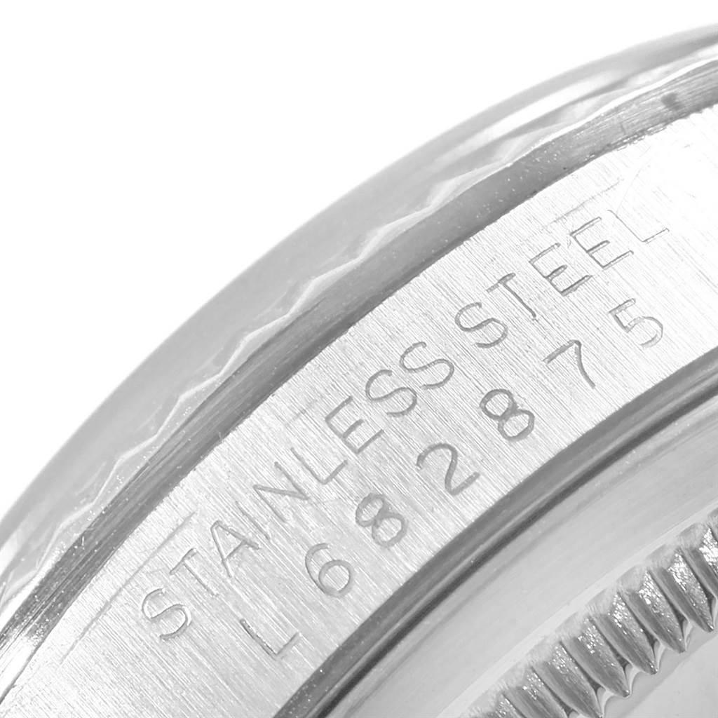 This close-up image shows the serial number engraving on the stainless steel case of a Rolex Datejust 16234 Men's Stainless Steel Silver Dial 16234 Men's Stainless Steel Silver Dial watch.