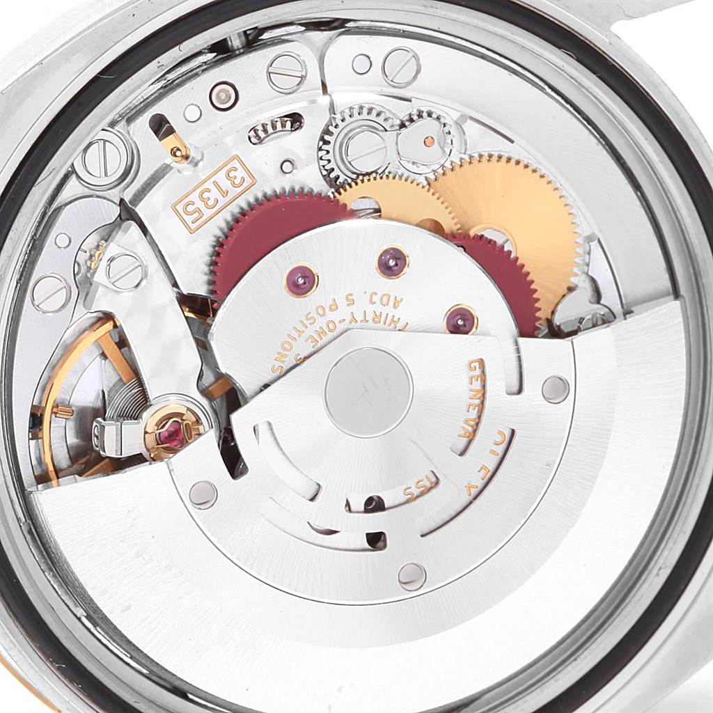 This image shows the internal movement of a Rolex Datejust 116233 Men's Stainless Steel Champagne Dial 116233 Men's Stainless Steel Champagne Dial watch at a close-up angle, highlighting gears and mechanical parts.