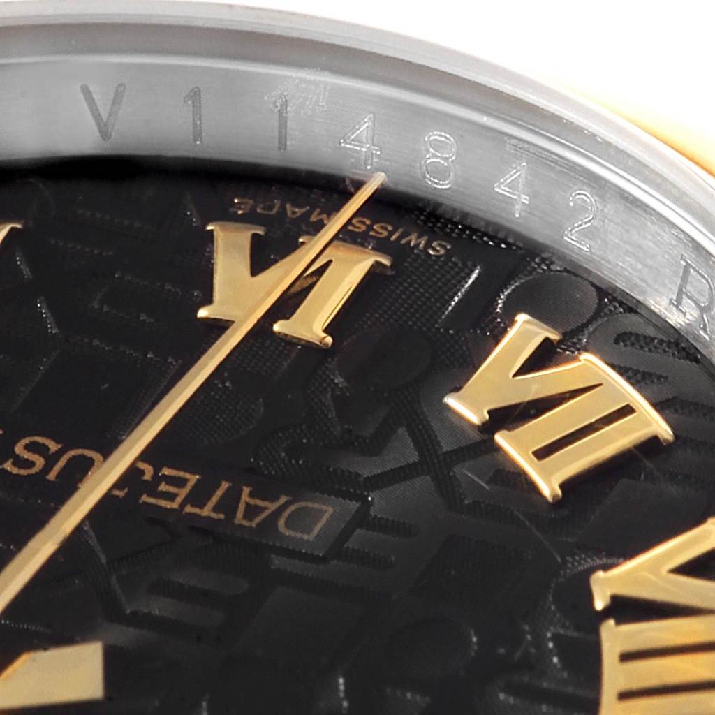 Close-up of a Rolex Datejust 116203 Men's Stainless Steel Black Dial 116203 Men's Stainless Steel Black Dial dial featuring gold Roman numerals and part of the watch's serial number on the inner bezel.