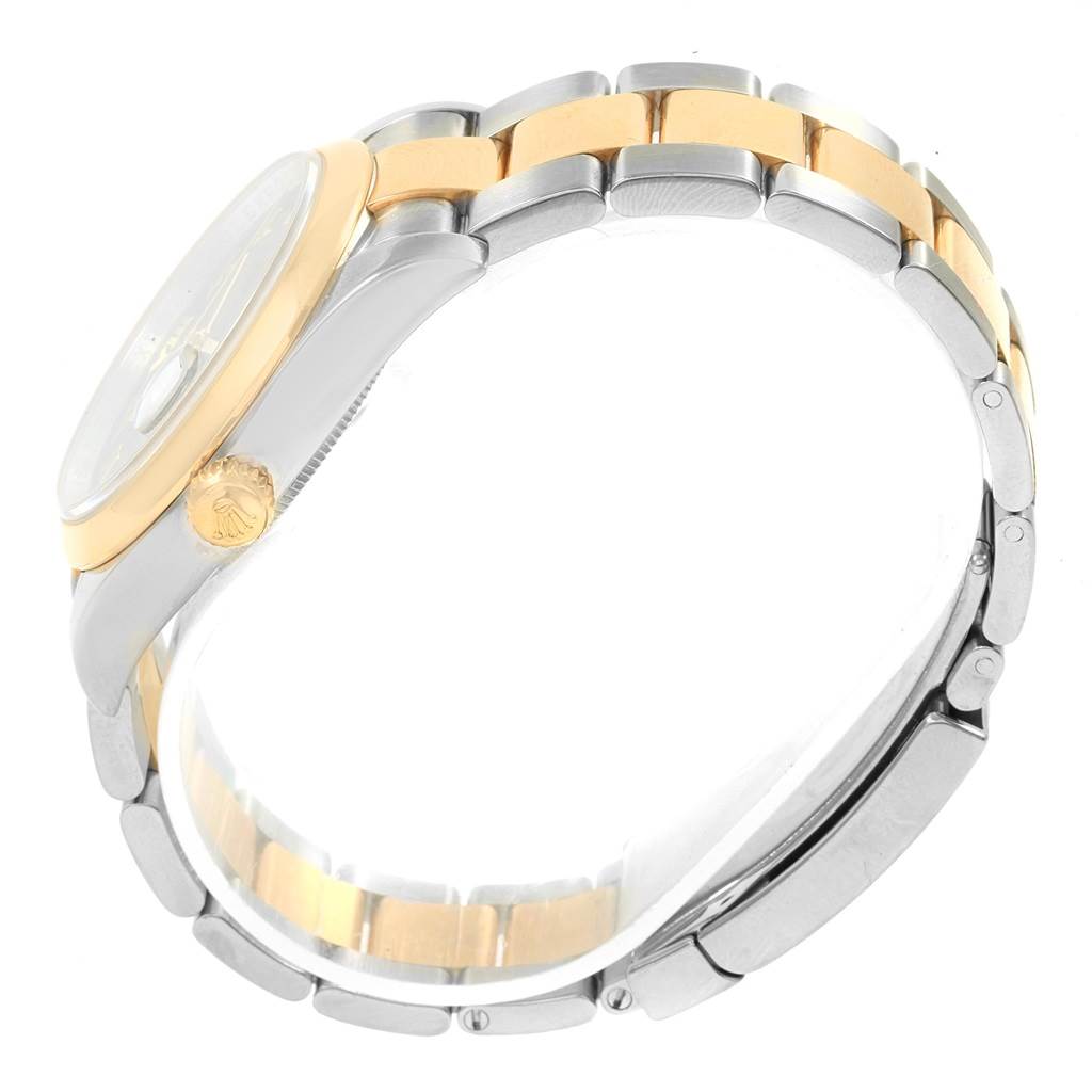The image shows a side view of a Datejust Rolex watch focusing on its bezel, crown, and two-tone bracelet.