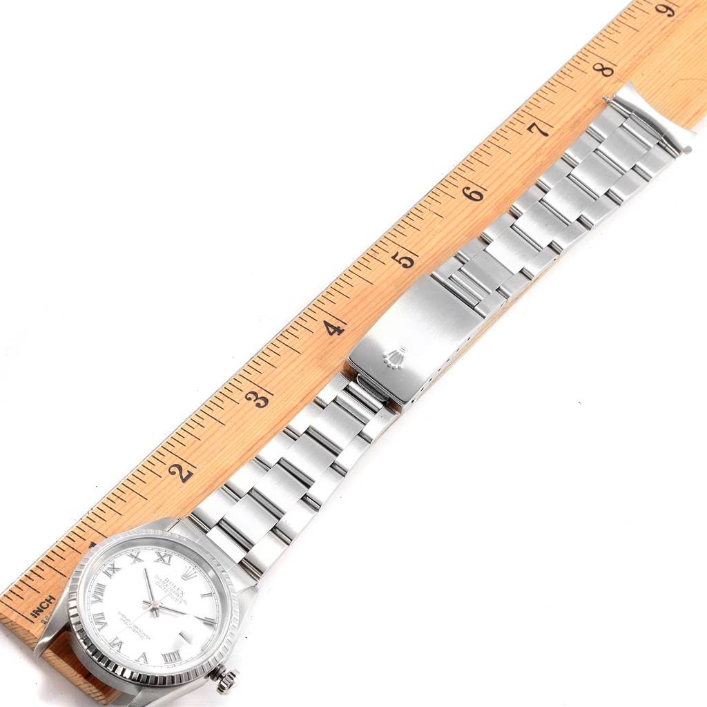 The image shows the Rolex Datejust 16220 Men's Stainless Steel White Dial 16220 Men's Stainless Steel White Dial watch laid flat next to a ruler, displaying the band and clasp.