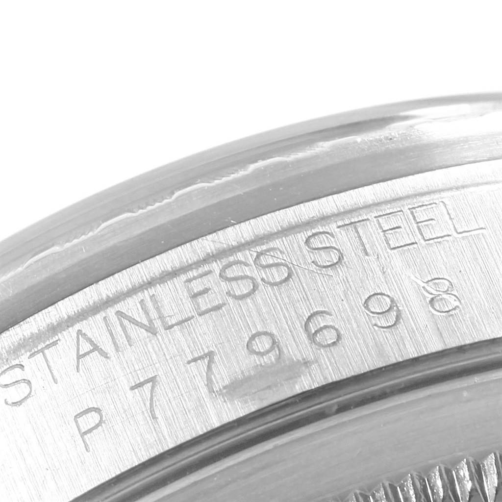 The image shows a close-up of the side of the case back of a Rolex Datejust 16220 Men's Stainless Steel White Dial 16220 Men's Stainless Steel White Dial model, highlighting its stainless steel and serial number.