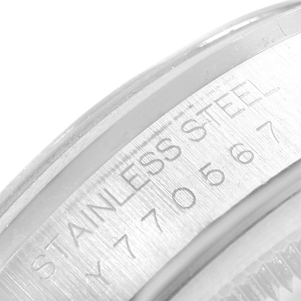 This image shows an engraved part of the bezel or case side of a Rolex Datejust 16200 Men's Stainless Steel Silver Dial 16200 Men's Stainless Steel Silver Dial model, highlighting the serial number and "STAINLESS STEEL" text.