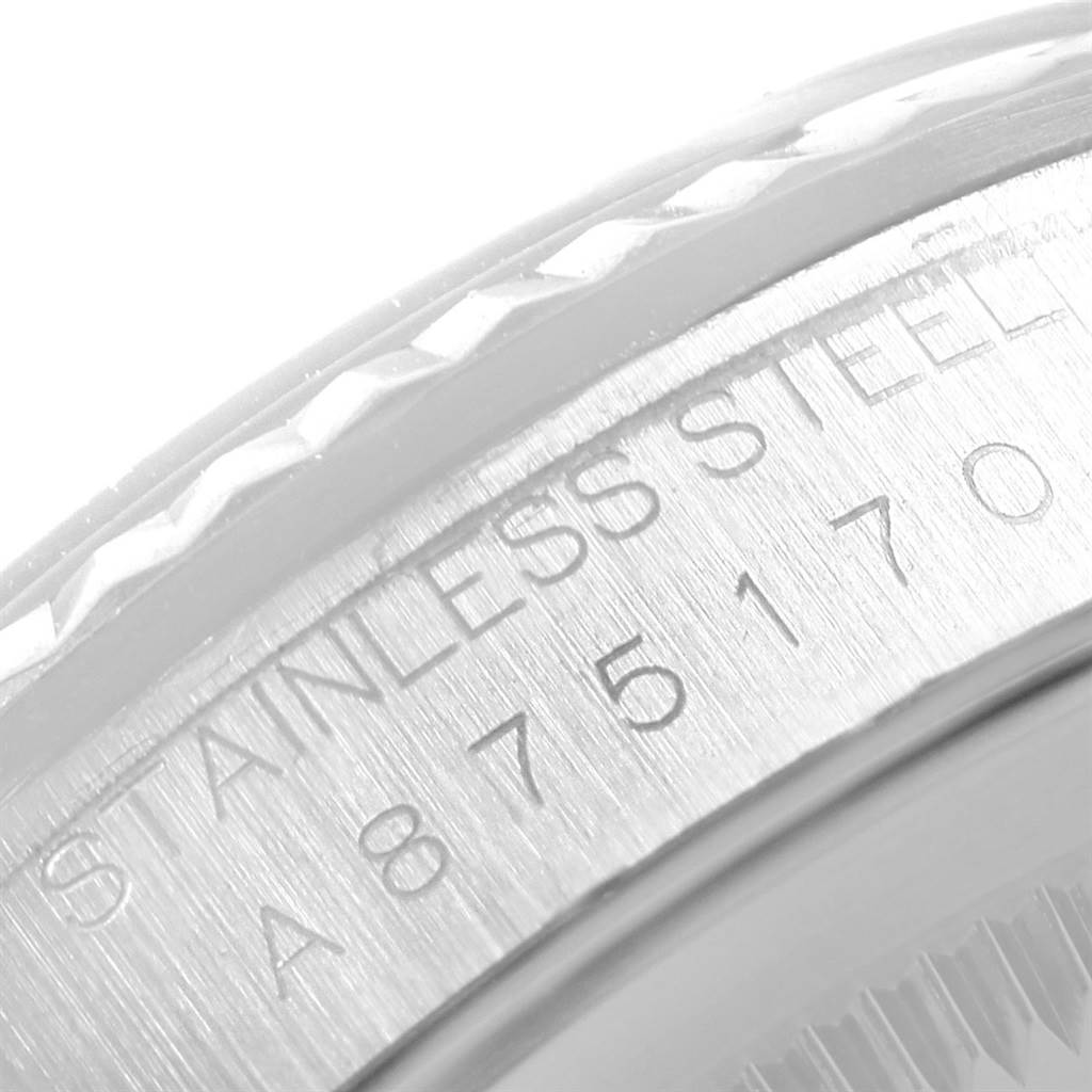 The image shows a close-up view of the Rolex Datejust 16234 Men's Stainless Steel Silver Dial 16234 Men's Stainless Steel Silver Dial's case, highlighting the serial number and "Stainless Steel" engraving.