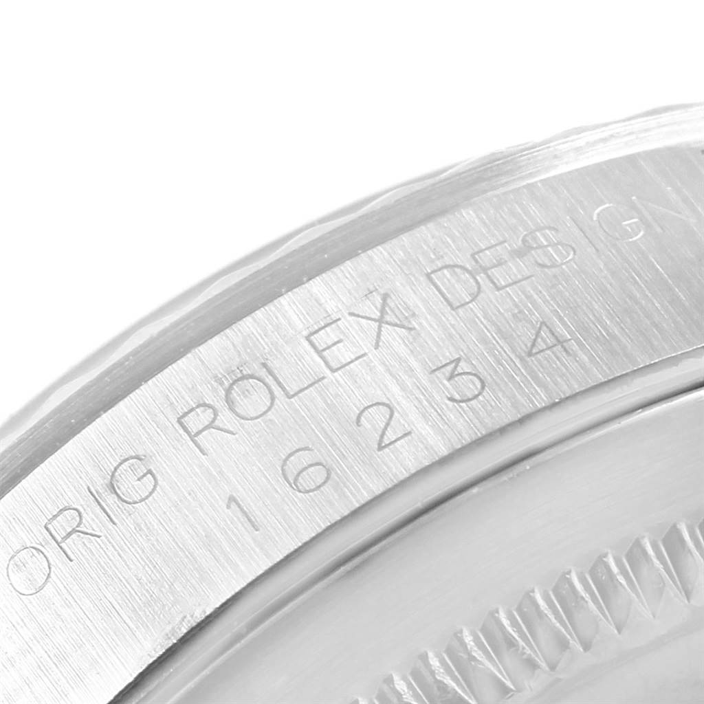 The image shows a close-up of the engraved bezel of a Rolex Datejust 16234 Men's Stainless Steel Silver Dial 16234 Men's Stainless Steel Silver Dial watch model.