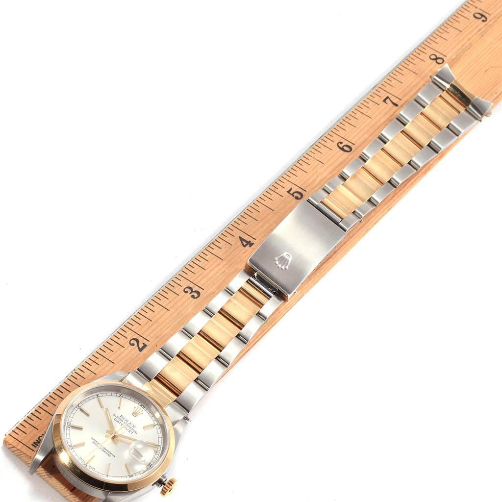 The image shows a Rolex Datejust 16203 Men's Steel and Gold (two tone) Silver Dial 16203 Men's Steel and Gold (two tone) Silver Dial watch laid flat next to a ruler, highlighting the watch face, bezel, and bracelet.