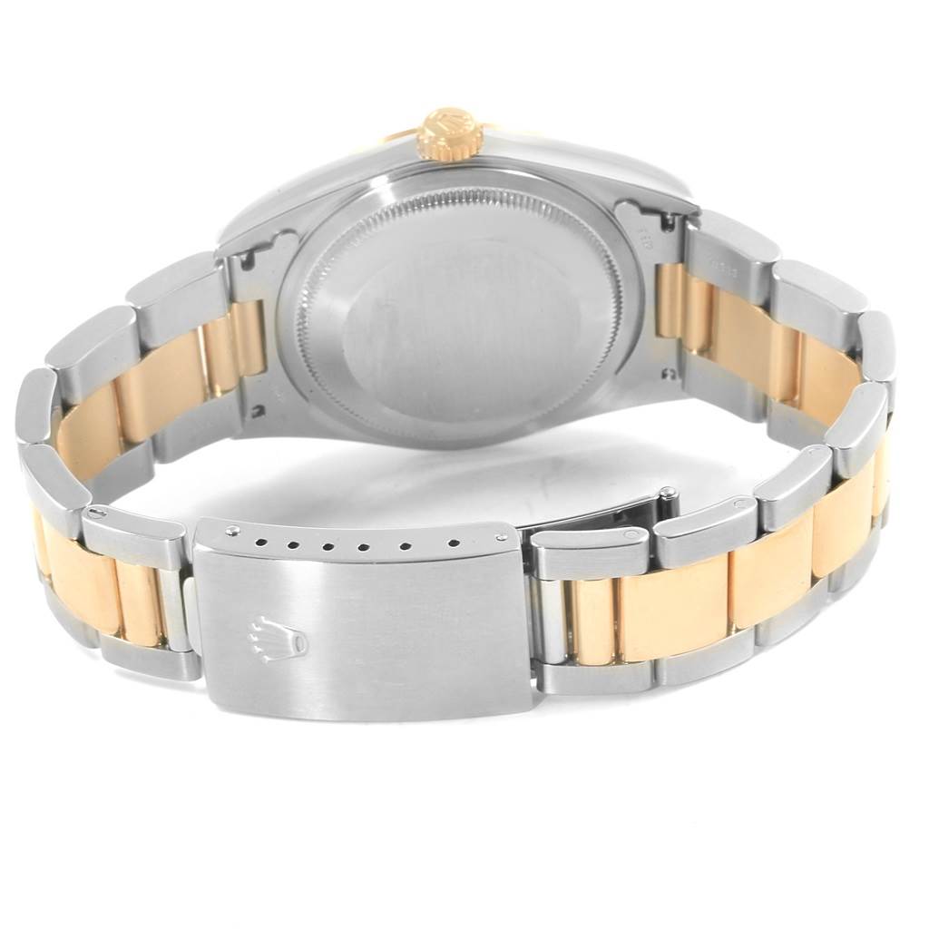 The image shows the back view of a Rolex Datejust 16203 Men's Steel and Gold (two tone) Silver Dial 16203 Men's Steel and Gold (two tone) Silver Dial watch, including its case back and the bracelet with a clasp.