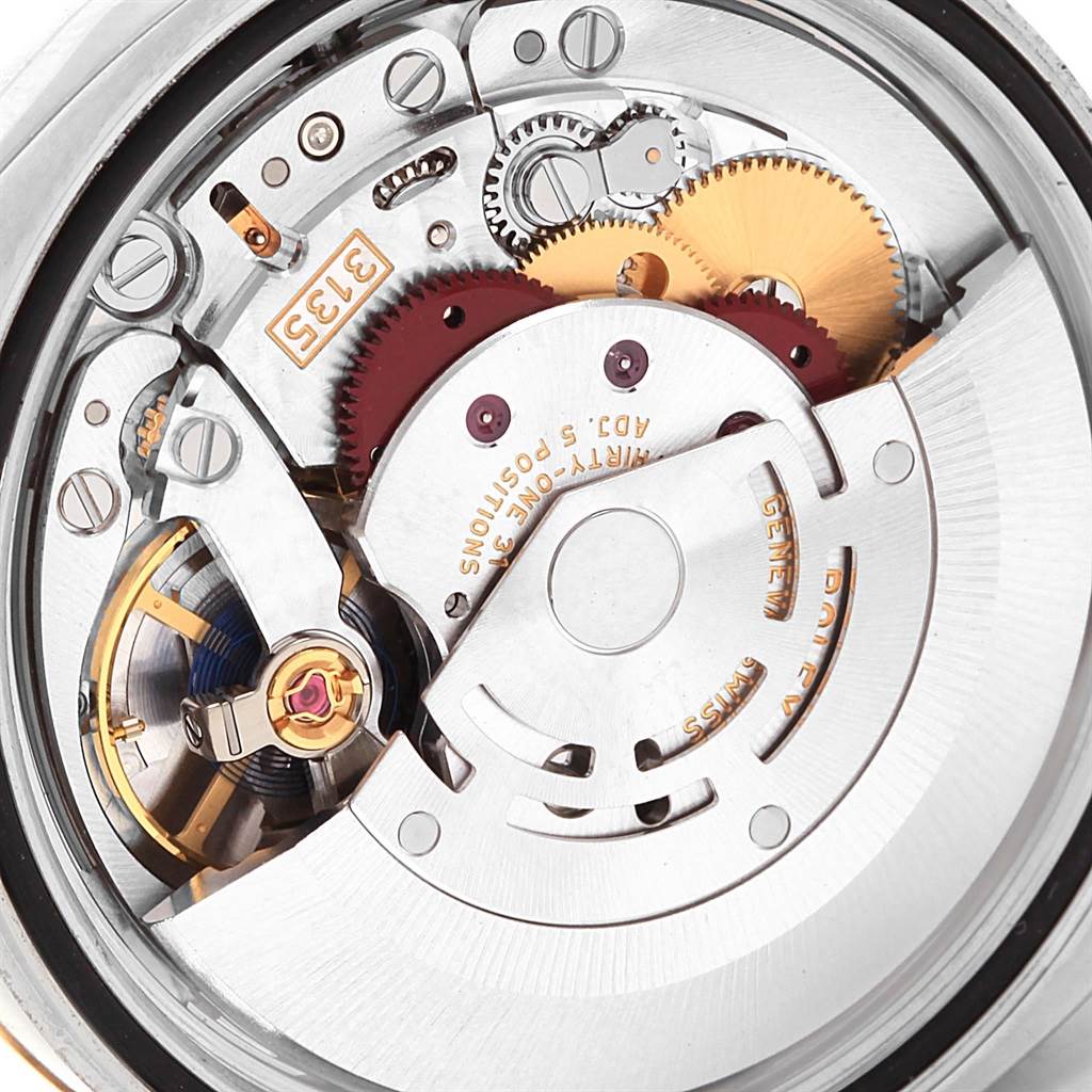 The image shows the inner mechanism of a Rolex Datejust 116203 Men's Stainless Steel Black Dial 116203 Men's Stainless Steel Black Dial watch from a close-up, focusing on its gears and movement components.