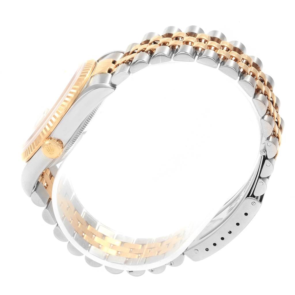 The image shows a side view of the Rolex Datejust 16233 Men's Steel and Gold (two tone) Champagne Dial 16233 Men's Steel and Gold (two tone) Champagne Dial model, highlighting the crown, fluted bezel, and two-tone Jubilee bracelet.