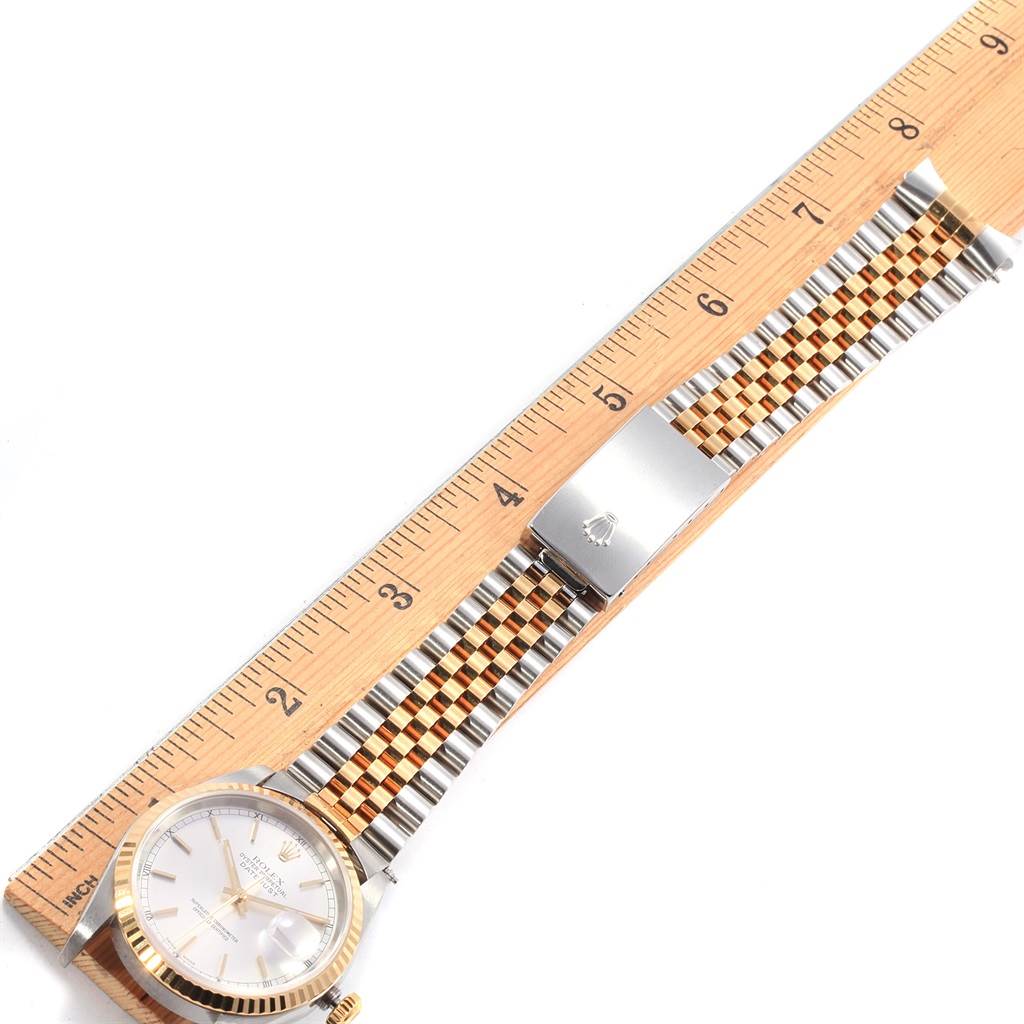 The Rolex Datejust 16233 Men's Steel and Gold (two tone) Silver Dial 16233 Men's Steel and Gold (two tone) Silver Dial watch is shown from a top-down angle, highlighting the dial, bracelet, and clasp.