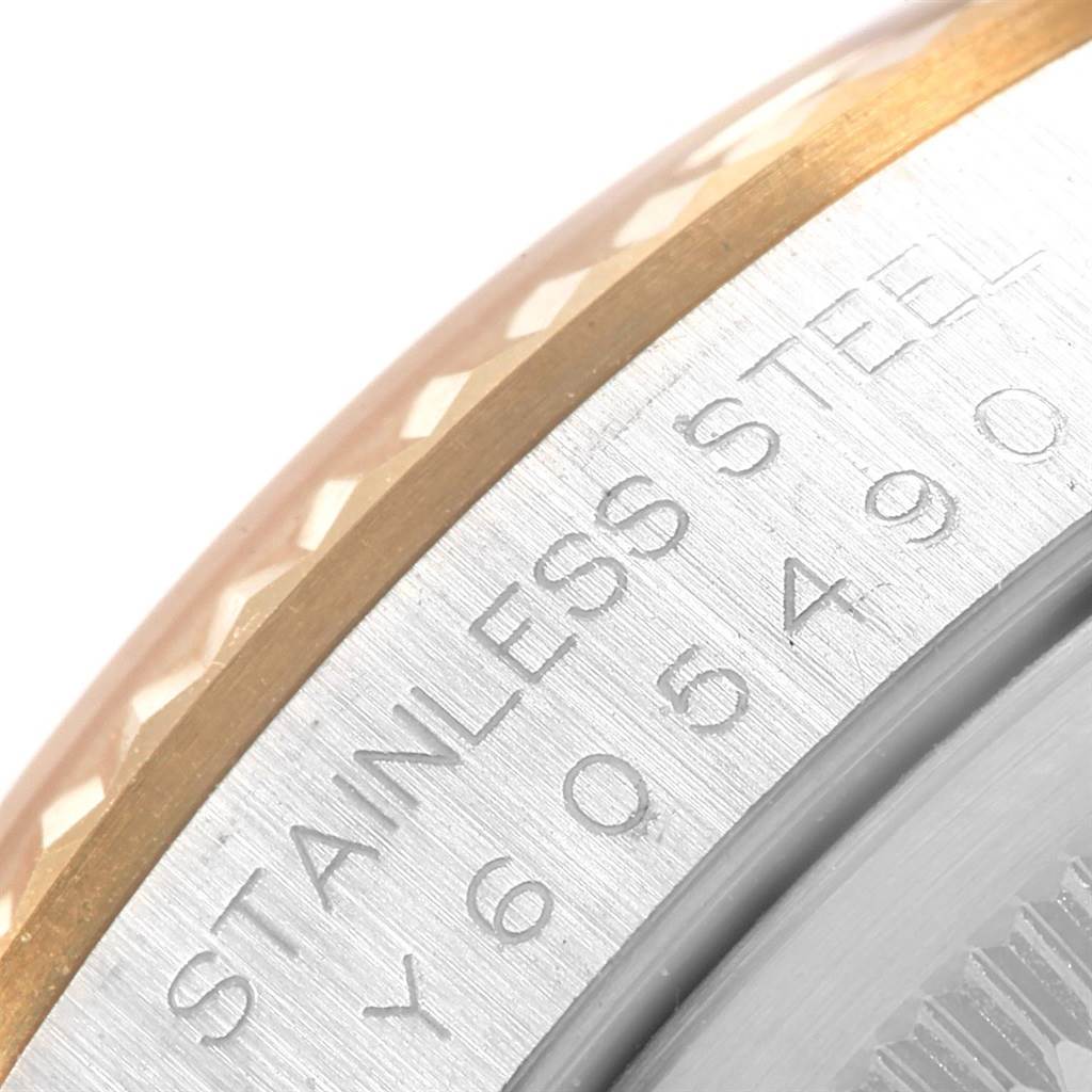 This close-up image shows the bezel and part of the case of a Rolex Datejust 16233 Men's Steel and Gold (two tone) Silver Dial 16233 Men's Steel and Gold (two tone) Silver Dial watch, featuring steel and gold components.