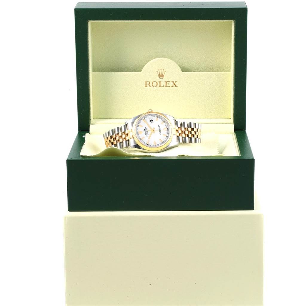 The Rolex Datejust 116233 Men's Stainless Steel White Dial 116233 Men's Stainless Steel White Dial watch is displayed front view, inside a green and beige Rolex box, showing its dial and bracelet.