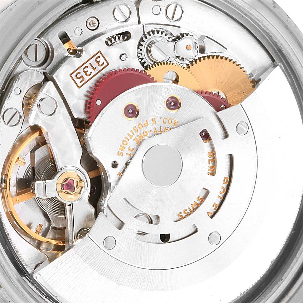 This image shows the internal mechanism of a Rolex Datejust 116233 Men's Stainless Steel White Dial 116233 Men's Stainless Steel White Dial watch, featuring gears and the rotor from a close-up angle.