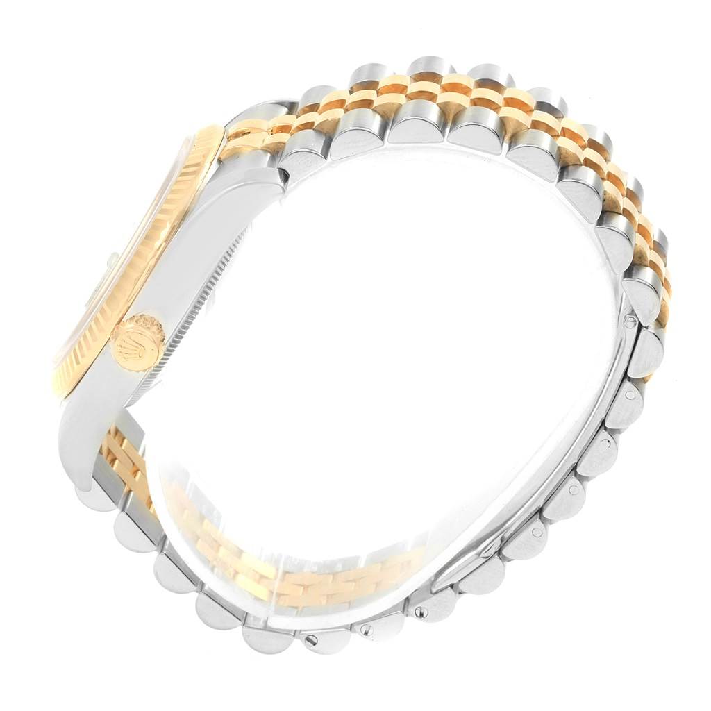 The image shows a side view of the Rolex Datejust 116233 Men's Stainless Steel White Dial 116233 Men's Stainless Steel White Dial watch highlighting its gold and silver jubilee bracelet and the fluted bezel.