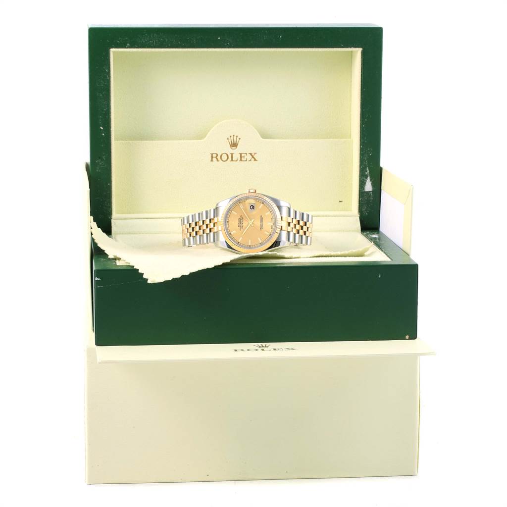 The Rolex Datejust 116233 Men's Stainless Steel Champagne Dial 116233 Men's Stainless Steel Champagne Dial watch is displayed in an open green and cream box, with the watch facing forward.