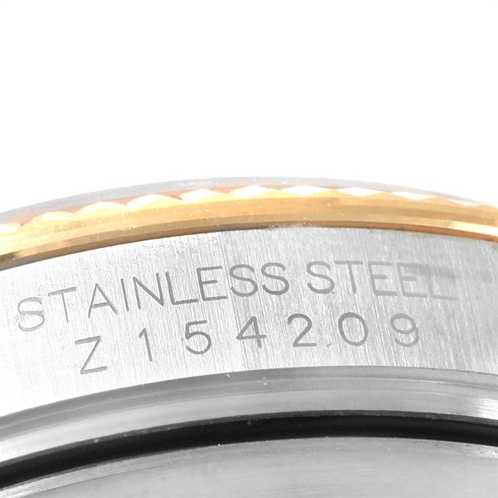 The image shows a close-up of the engraved case of a Rolex Datejust 116233 Men's Stainless Steel Champagne Dial 116233 Men's Stainless Steel Champagne Dial watch, highlighting the stainless steel and serial number.