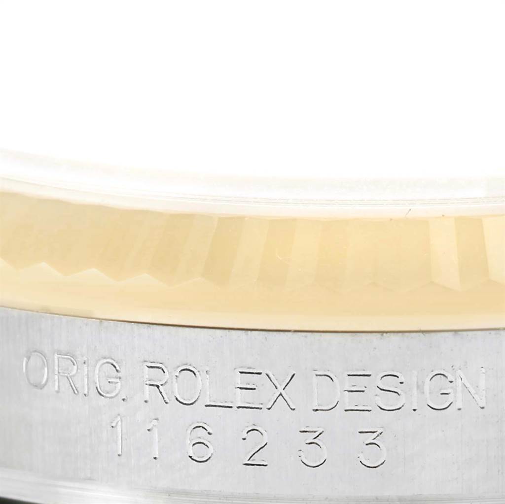 This close-up image shows the side view of a Rolex Datejust 116233 Men's Stainless Steel Champagne Dial 116233 Men's Stainless Steel Champagne Dial watch case, displaying the model number and "ORIG. ROLEX DESIGN" engraving.