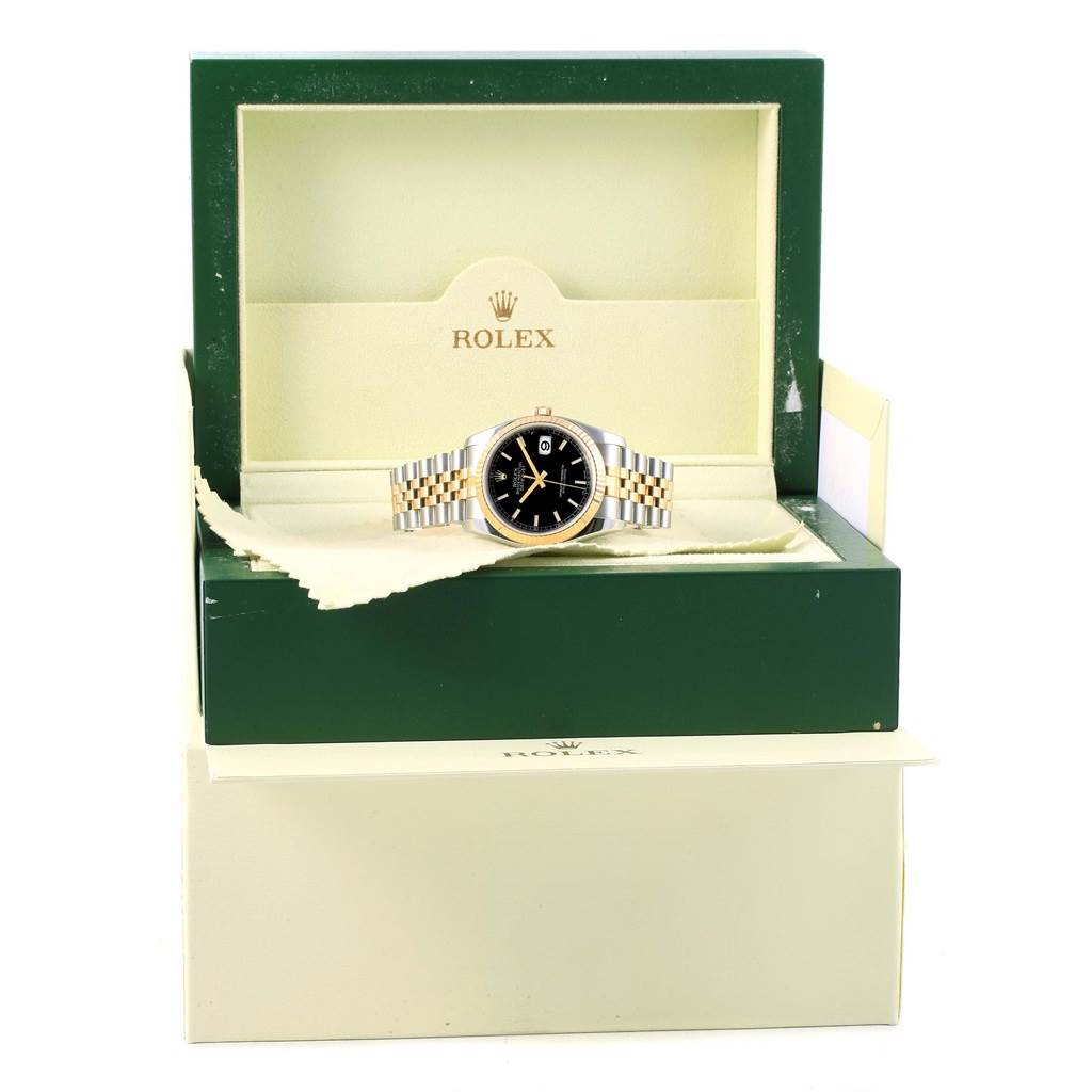 This is a front-angle view of a Rolex Datejust 116233 Men's Stainless Steel Black Dial 116233 Men's Stainless Steel Black Dial watch, presented in its open green and cream-colored box.