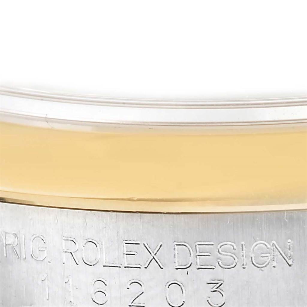 This image shows a close-up of the edge of the bezel and part of the casing with engraving on a Rolex Datejust 116203 Men
s Stainless Steel Black Dial 116203 Men
s Stainless Steel Black Dial watch.