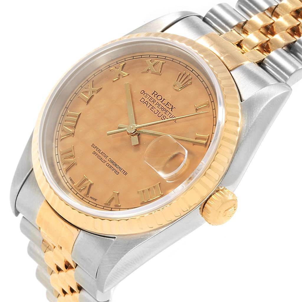 This angled view of the Rolex Datejust 16233 Men's Steel and Gold (two tone) Beige Dial 16233 Men's Steel and Gold (two tone) Beige Dial watch highlights its gold and steel bracelet, bezel, and peach-colored Roman numeral dial.