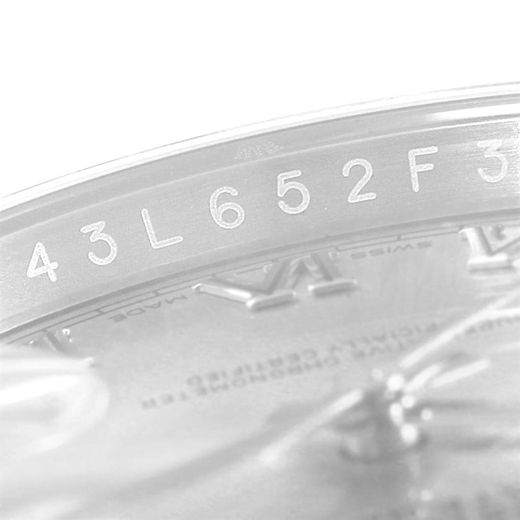 This close-up image of a Rolex Datejust 116200 Men's Stainless Steel Silver Dial 116200 Men's Stainless Steel Silver Dial watch shows the serial number engraved on the case and part of the dial.